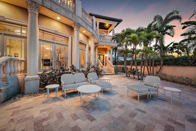 patio terrace at dusk with a balcony