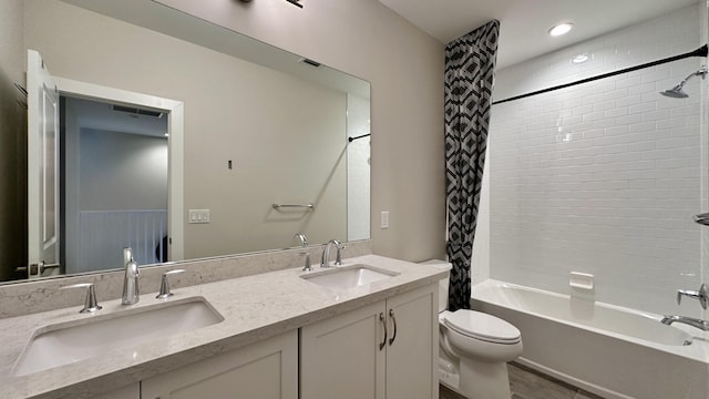 full bathroom featuring vanity, shower / bath combo, and toilet