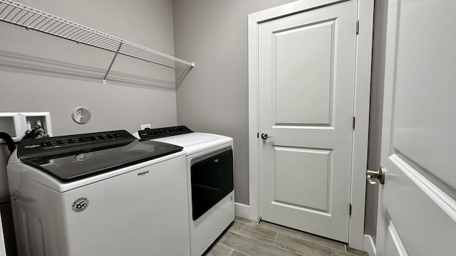 clothes washing area featuring washer and dryer