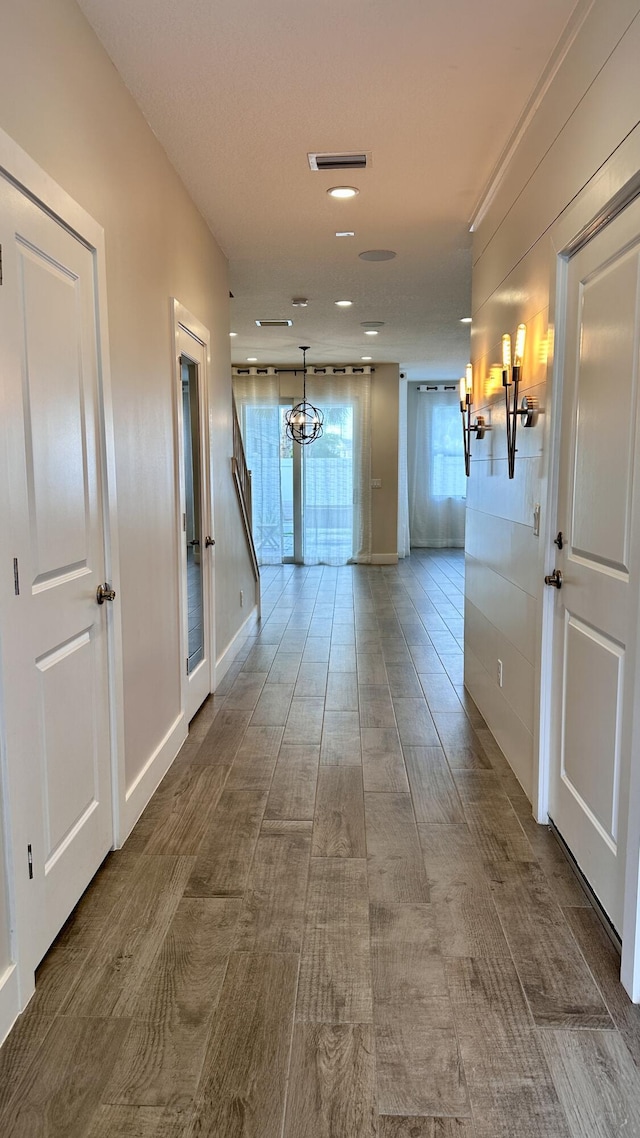 corridor with a chandelier