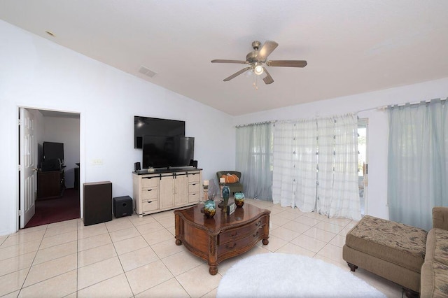 living room featuring ceiling fan, light tile patterned floors, and lofted ceiling