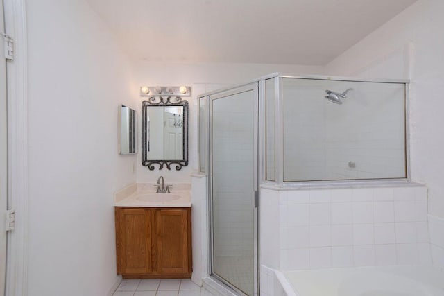 bathroom featuring tile patterned flooring, vanity, and shower with separate bathtub