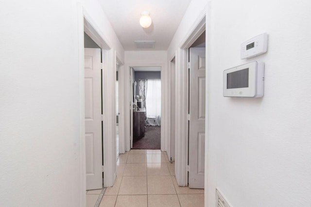 corridor with light tile patterned floors