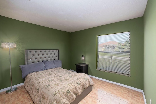 bedroom featuring light tile patterned flooring