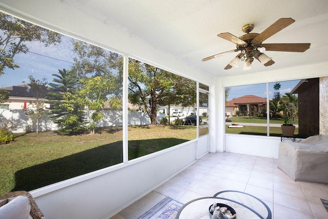 unfurnished sunroom with ceiling fan