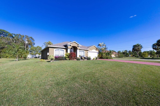 ranch-style house featuring a front yard and a garage