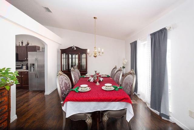 dining room featuring dark hardwood / wood-style flooring and an inviting chandelier