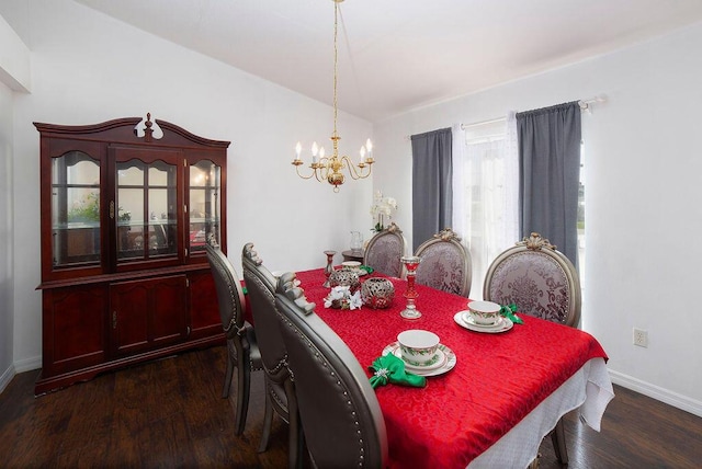 dining area with dark hardwood / wood-style flooring and a notable chandelier