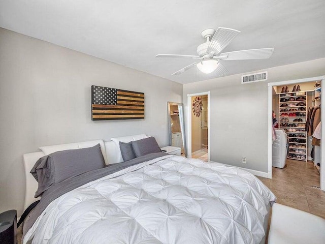 bedroom with ceiling fan, ensuite bath, a walk in closet, and a closet