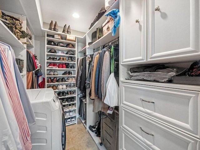 walk in closet with washing machine and dryer