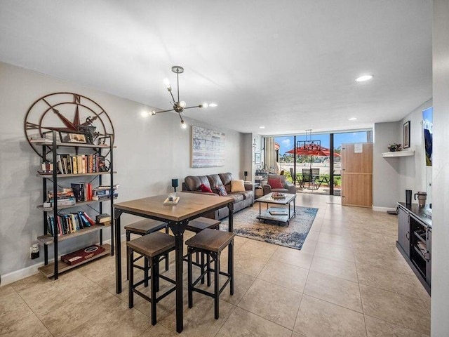 dining area featuring a chandelier and a wall of windows