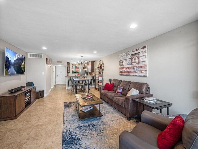 living room featuring light tile patterned floors and a chandelier