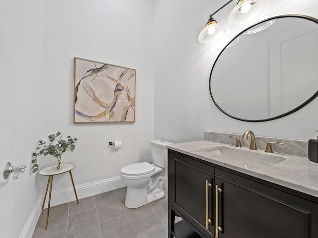 bathroom with toilet, tile patterned flooring, and vanity