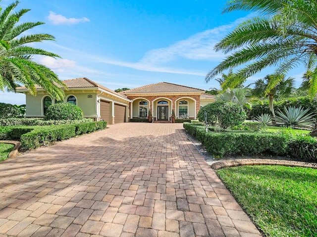 mediterranean / spanish-style home with a porch and a garage