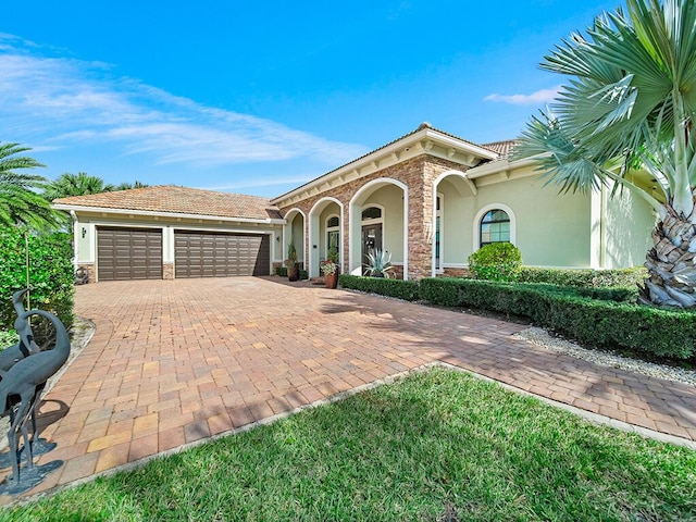 mediterranean / spanish-style home with a garage