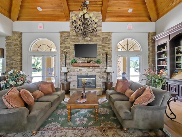 living room featuring wood ceiling, high vaulted ceiling, beam ceiling, and french doors