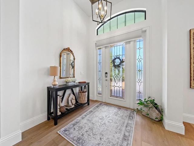 foyer with hardwood / wood-style floors and an inviting chandelier