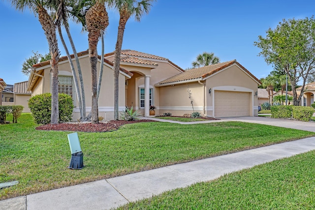 mediterranean / spanish-style house with a front lawn and a garage