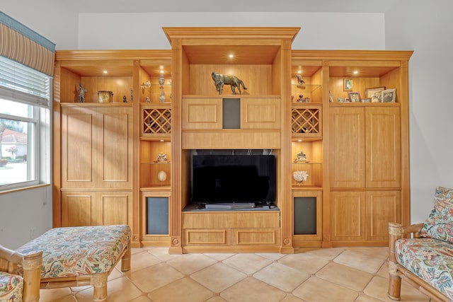 living room featuring built in shelves and light tile patterned flooring