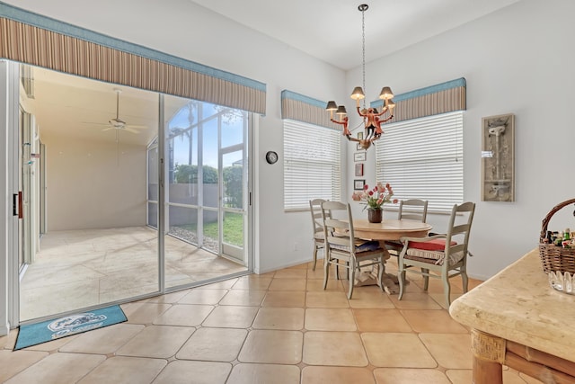 dining area featuring ceiling fan with notable chandelier