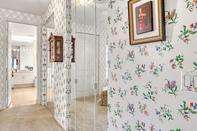 bathroom featuring vanity, tile patterned floors, and a textured ceiling