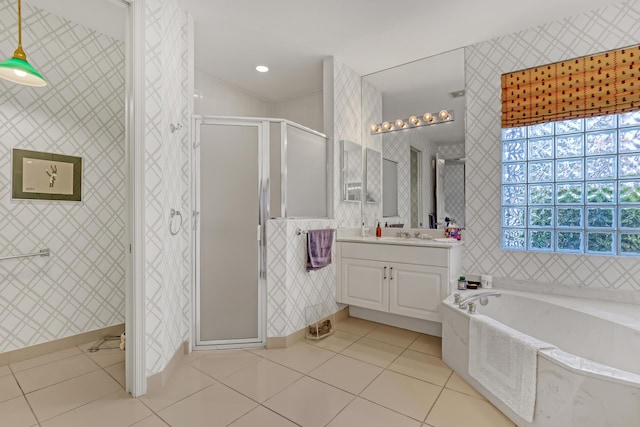 bathroom featuring tile patterned floors, independent shower and bath, and vanity