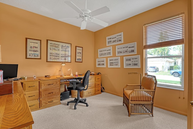 office space featuring ceiling fan and light carpet