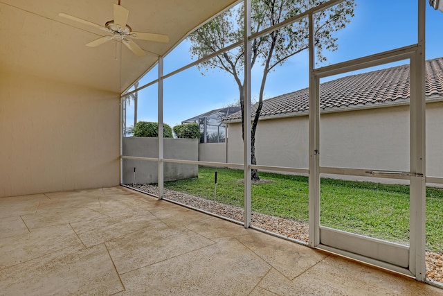 unfurnished sunroom with lofted ceiling and ceiling fan