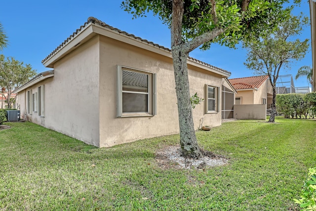 view of property exterior featuring a yard and central AC unit