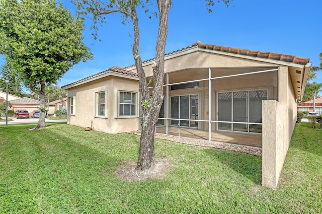 rear view of house with a patio area and a yard