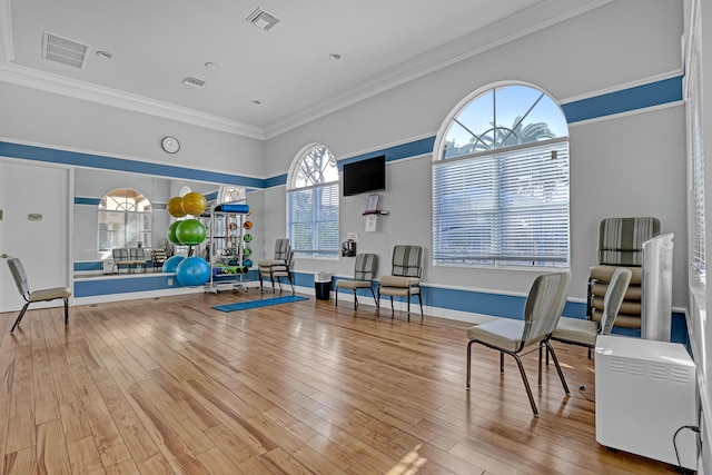 sitting room featuring ornamental molding, hardwood / wood-style floors, and a wealth of natural light