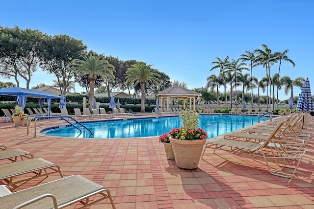 view of swimming pool with a patio and a gazebo