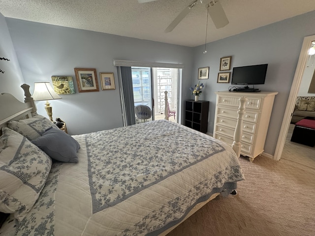 bedroom featuring ceiling fan, light colored carpet, and a textured ceiling