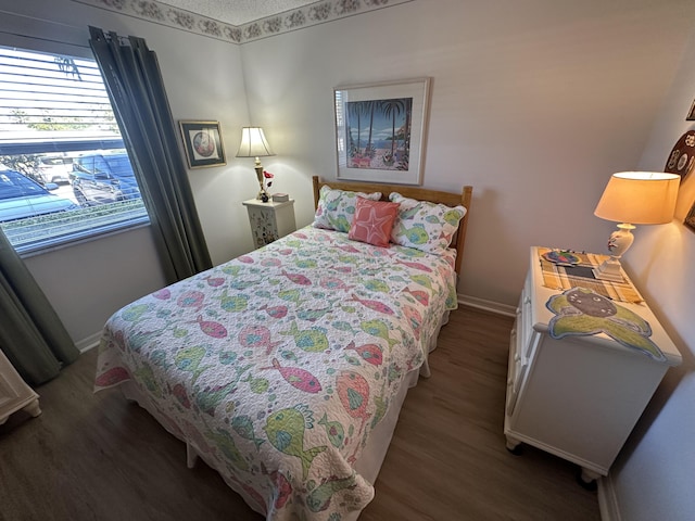 bedroom with hardwood / wood-style floors