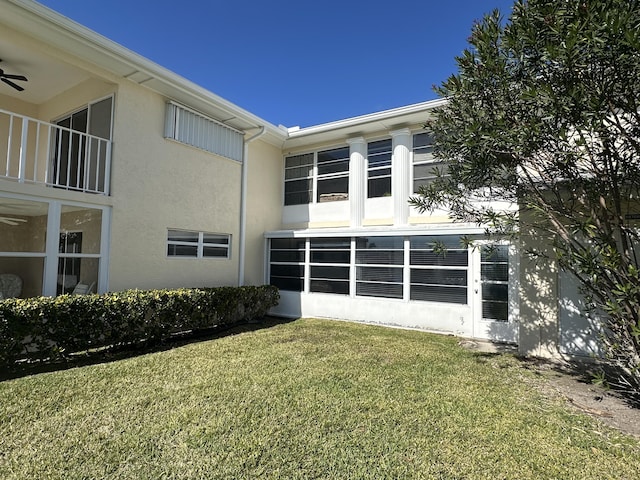 back of house with a lawn