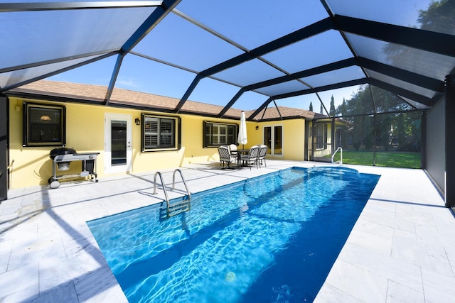 view of swimming pool featuring a patio area and a lanai