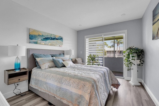 bedroom featuring access to exterior and light hardwood / wood-style floors