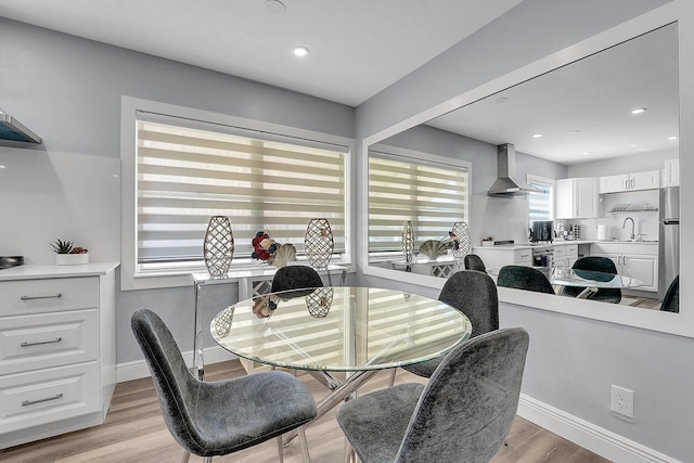 dining area featuring light hardwood / wood-style flooring and sink