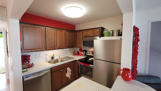 kitchen featuring tasteful backsplash, sink, and appliances with stainless steel finishes