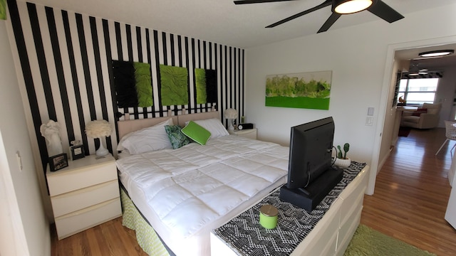 bedroom featuring hardwood / wood-style flooring and ceiling fan