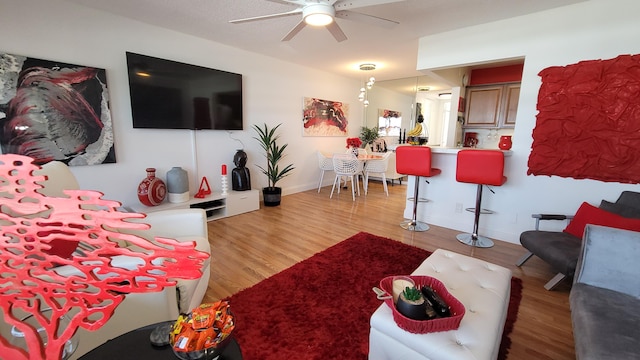 living room featuring ceiling fan and light hardwood / wood-style floors