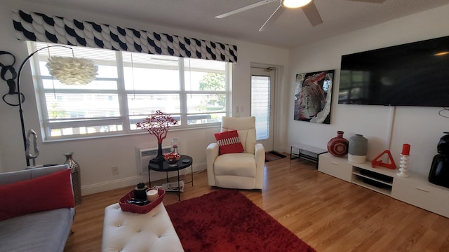 living room with light wood-type flooring and ceiling fan