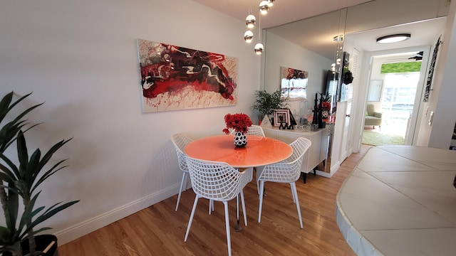 dining area with light hardwood / wood-style floors