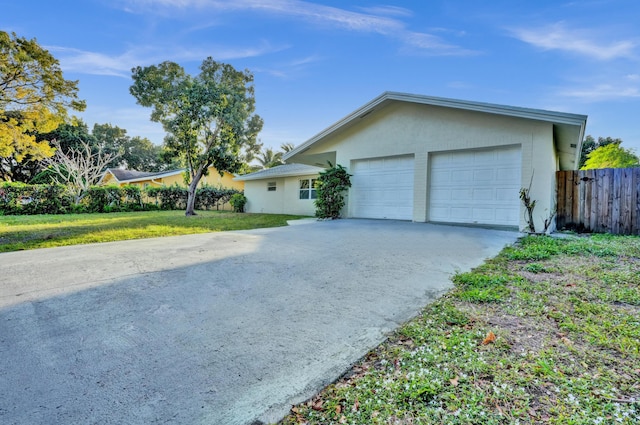 view of front of property featuring a front yard and a garage