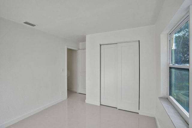 unfurnished bedroom with a closet