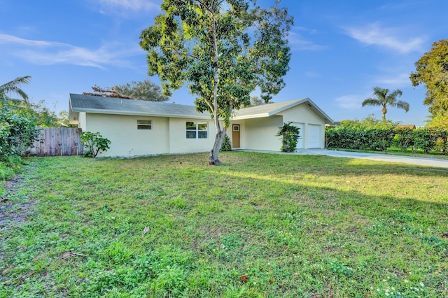 view of front of property with a front yard and a garage