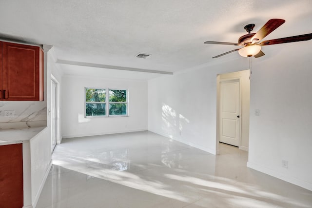 unfurnished living room with a textured ceiling and ceiling fan