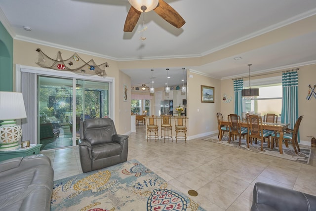 living room featuring ceiling fan, light tile patterned floors, and crown molding