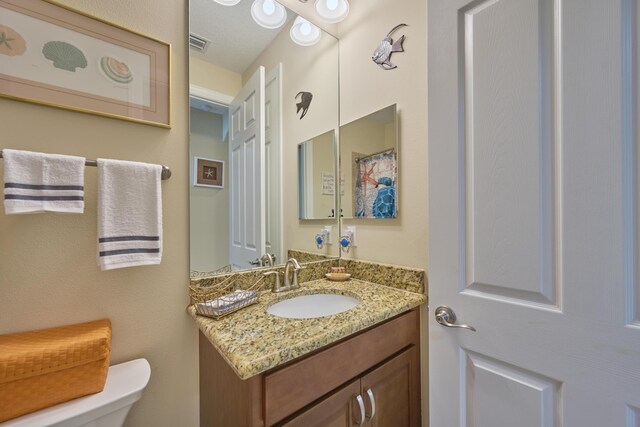 bedroom with crown molding, visible vents, carpet flooring, ceiling fan, and baseboards