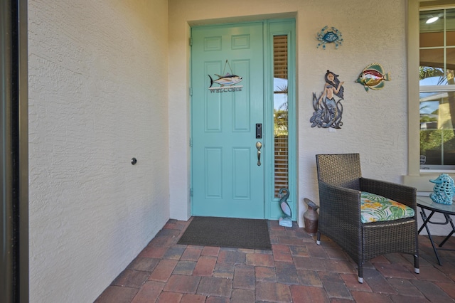 doorway to property featuring stucco siding